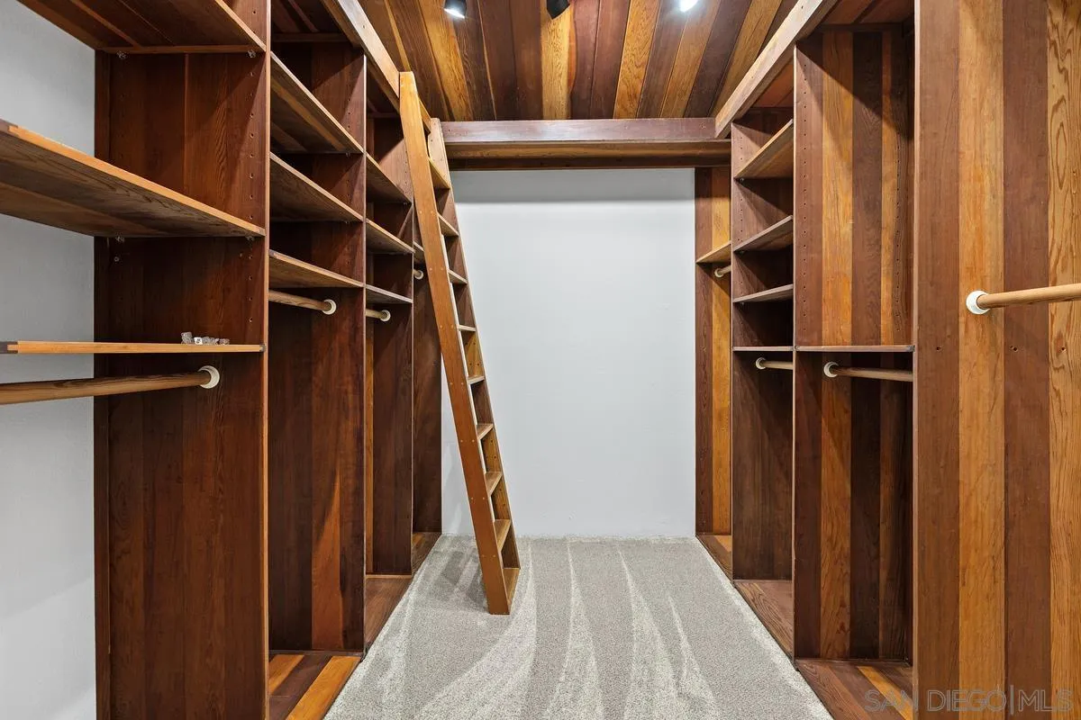 30830 Ranch Creek Road Valley Center, CA 92082 - Photo 18 of 50 a view of walk in closet with clothes and shoes