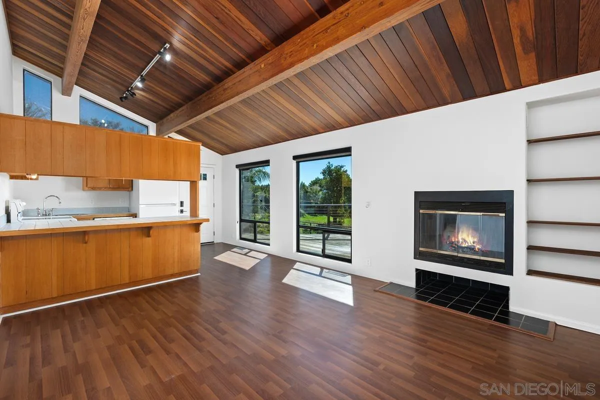 30830 Ranch Creek Road Valley Center, CA 92082 - Photo 27 of 50 a view of an empty room with wooden floor a fireplace and a window