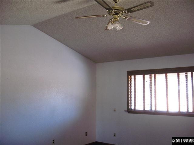 2849 Wade Street Minden, NV 89423 - Photo 5 of 13 an empty room with windows and ceiling fan