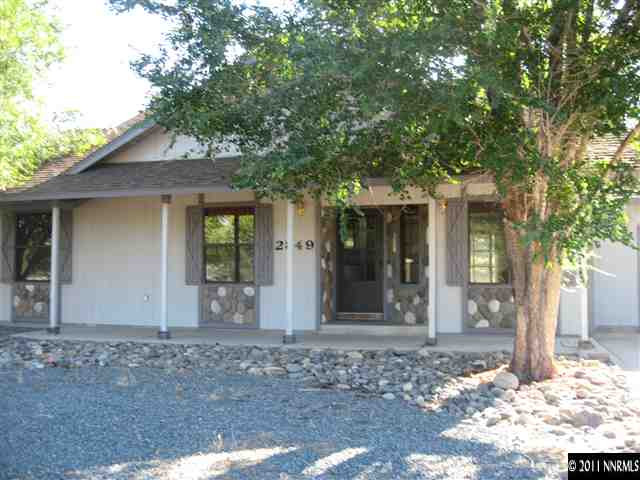 2849 Wade Street Minden, NV 89423 - Photo 7 of 13 a front view of a house with a tree