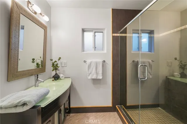 a bathroom with a granite countertop sink mirror vanity and toilet