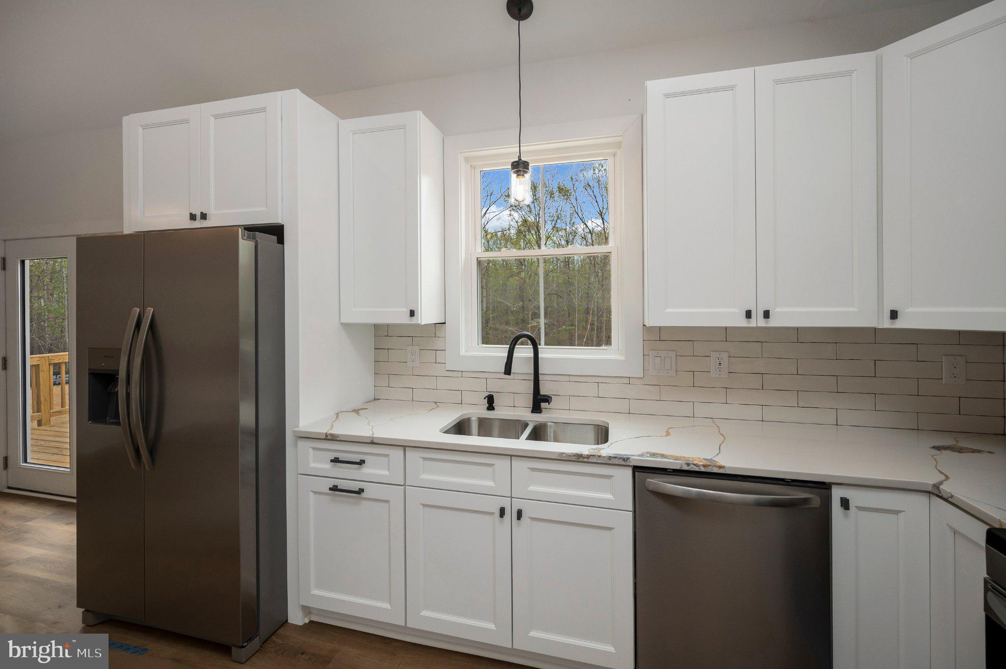 17342 Mallorys Ford Road Gordonsville, VA 22942 - Photo 24 of 38 a kitchen with stainless steel appliances white cabinets and a sink