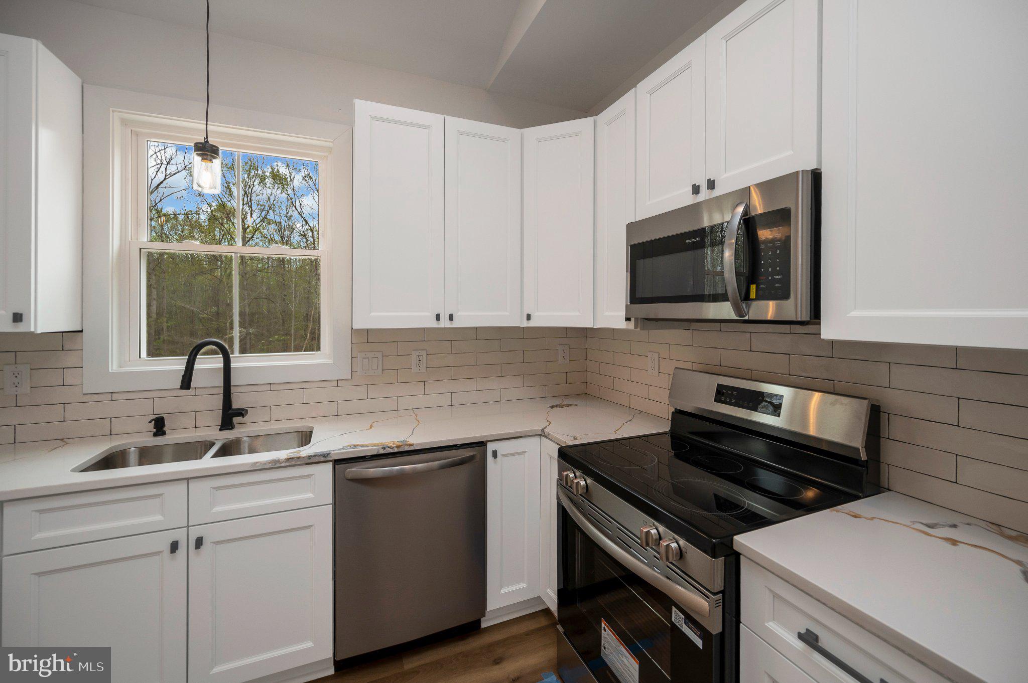17342 Mallorys Ford Road Gordonsville, VA 22942 - Photo 25 of 38 a kitchen with a sink stove and microwave
