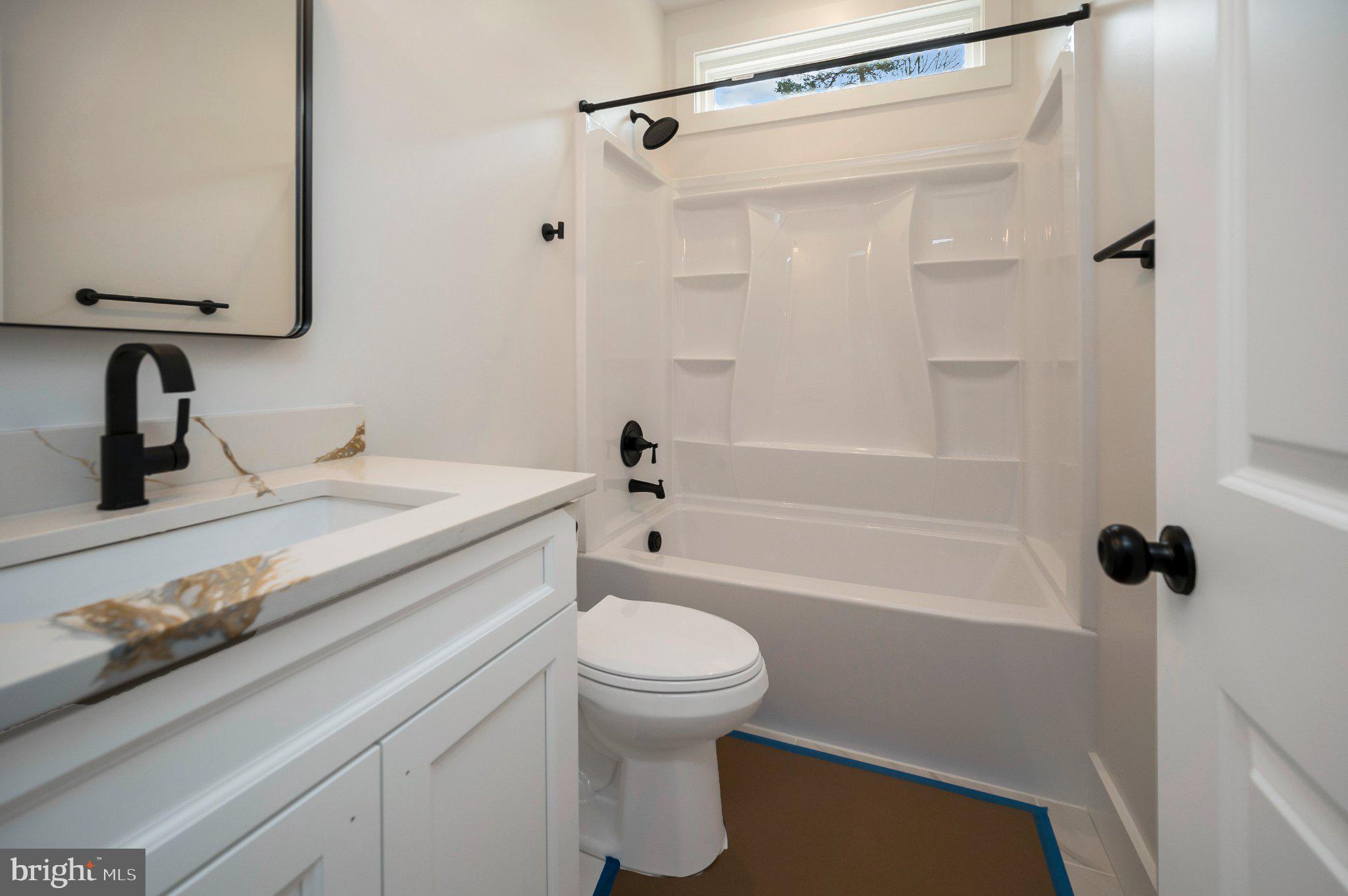 17342 Mallorys Ford Road Gordonsville, VA 22942 - Photo 35 of 38 a bathroom with a granite countertop sink a toilet and shower