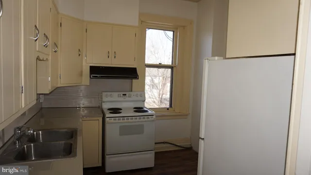 a kitchen with a refrigerator and a sink