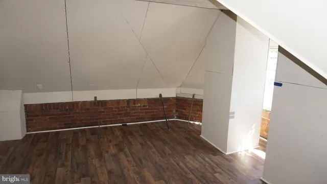 a view of hallway with stairs and wooden floor