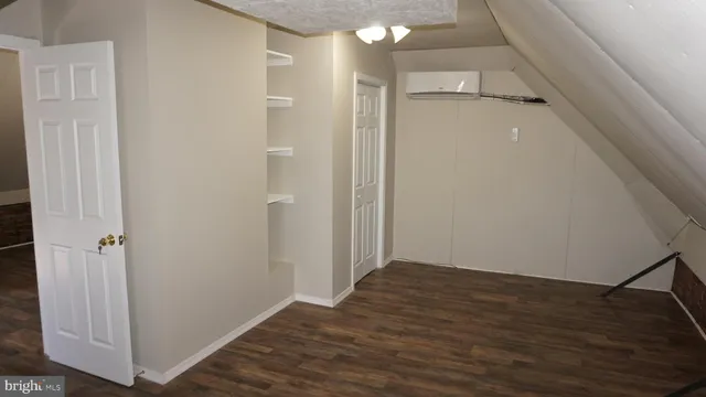 a view of a hallway view with wooden floor and staircase