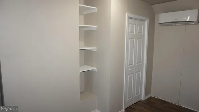 a view of a hallway with wooden floor and entryway
