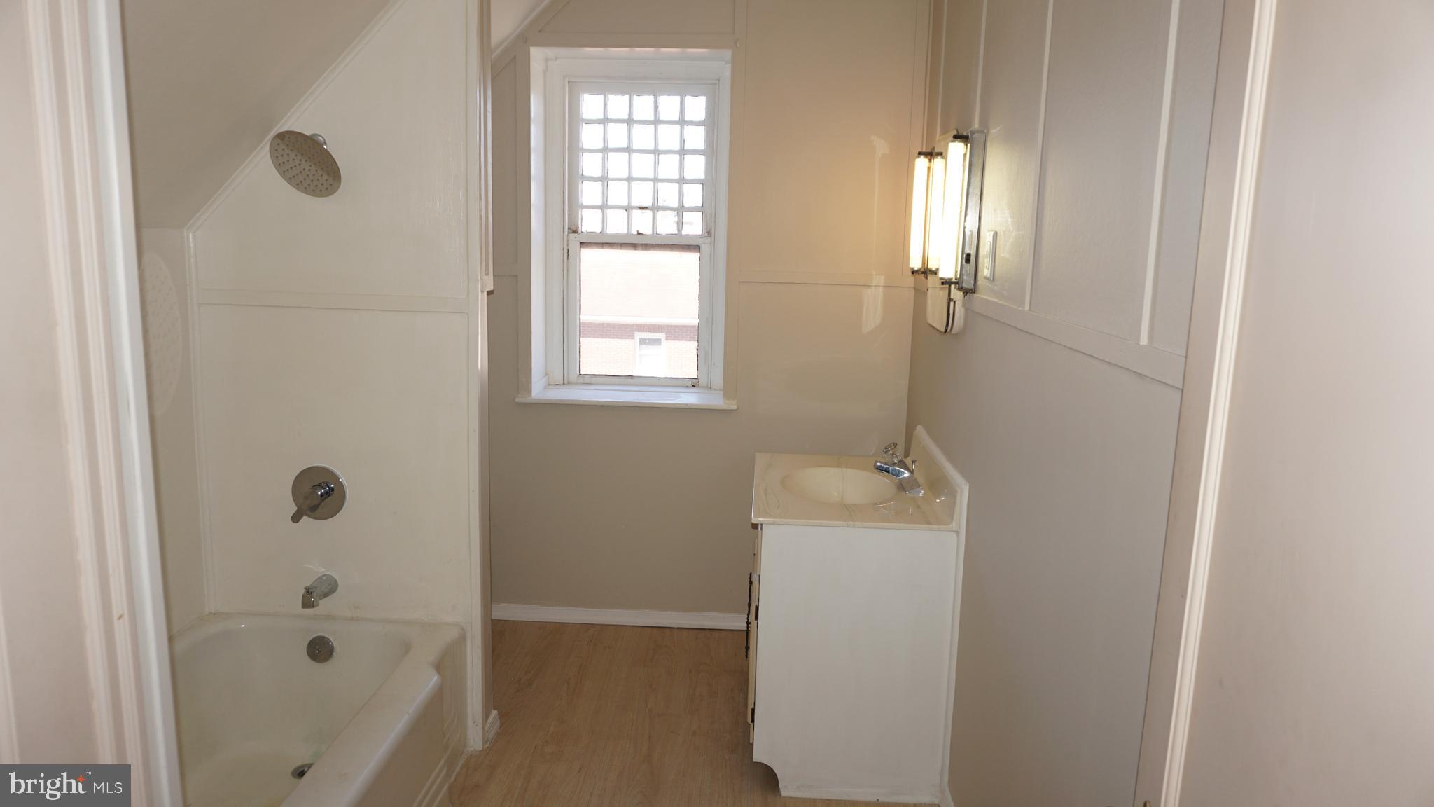200 East Walnut Street, Unit 4 Hanover, PA 17331 - Photo 40 of 47 a bathroom with a tub sink a window and shower