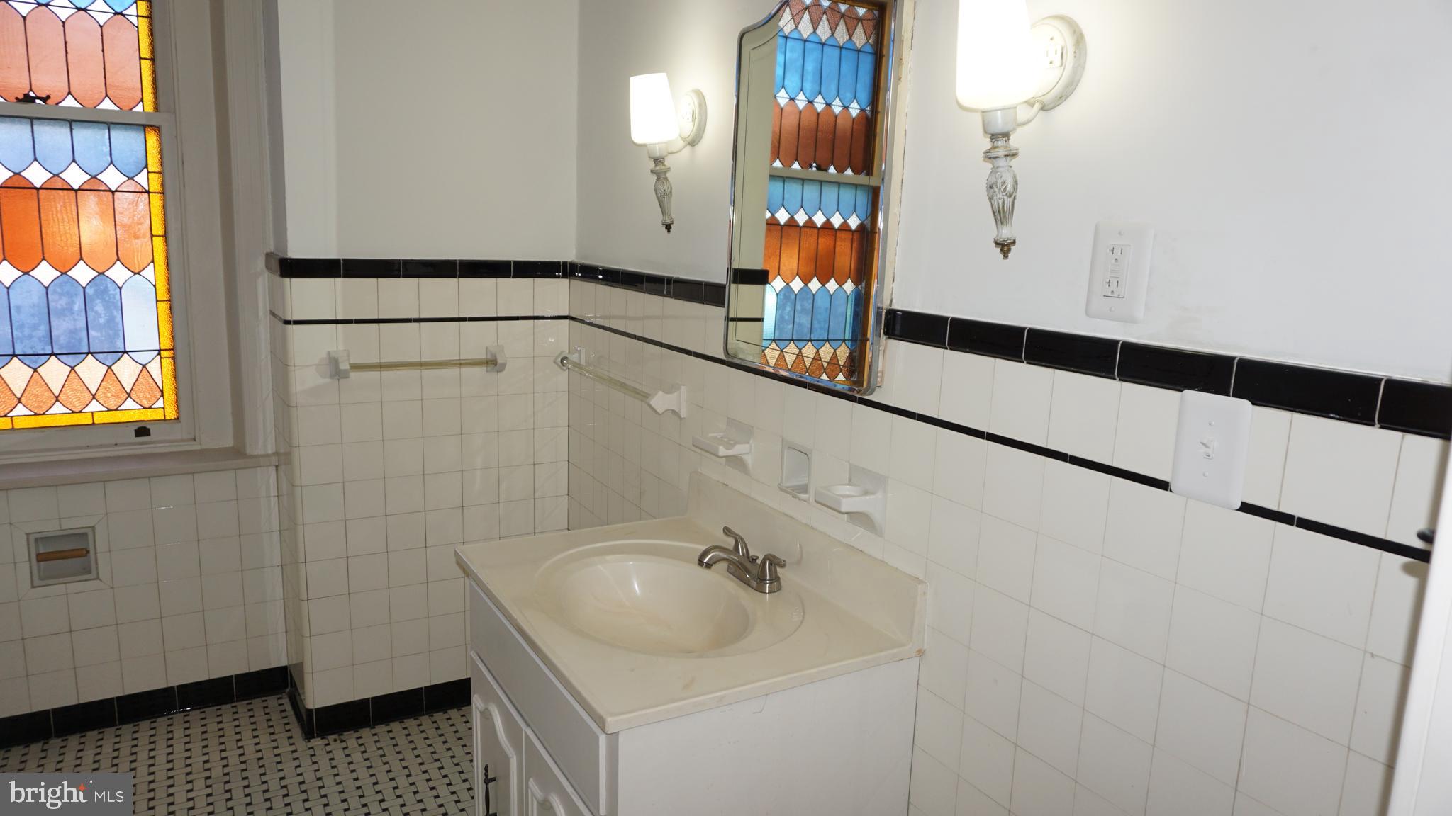 200 East Walnut Street, Unit 4 Hanover, PA 17331 - Photo 5 of 47 a bathroom with a sink and a mirror