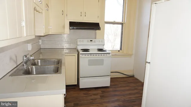 a kitchen with a stove a microwave and a refrigerator
