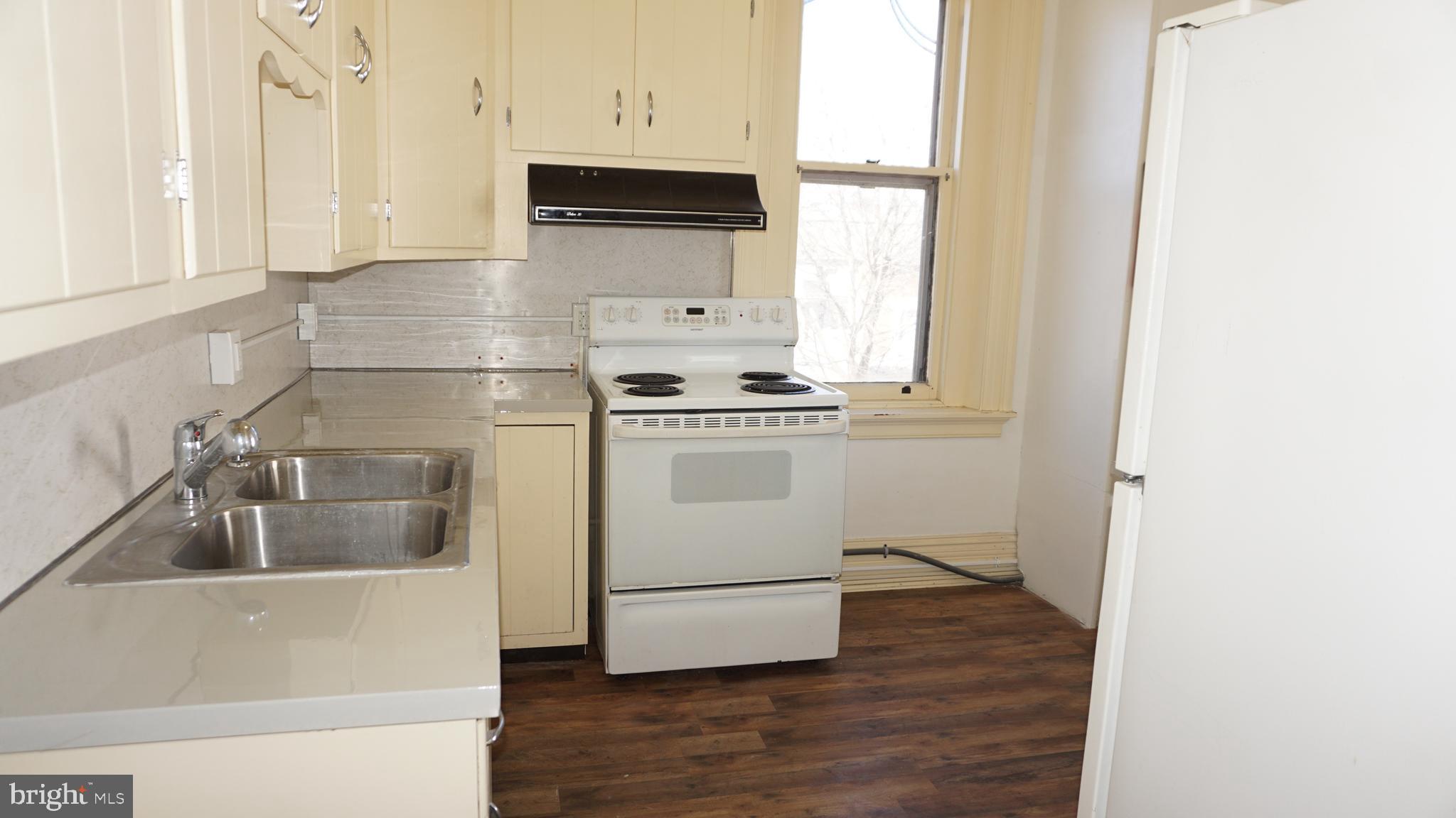 200 East Walnut Street, Unit 4 Hanover, PA 17331 - Photo 6 of 47 a kitchen with a stove a microwave and a refrigerator