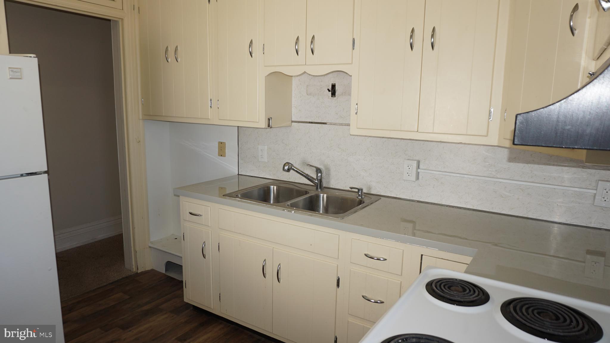 200 East Walnut Street, Unit 4 Hanover, PA 17331 - Photo 8 of 47 a kitchen with white cabinets and sink