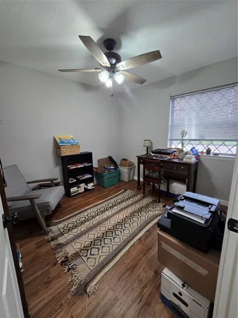 a view of a workspace with furniture and a window