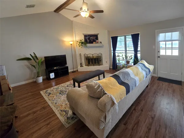a living room with furniture fireplace and a flat screen tv