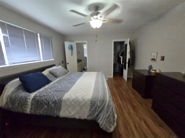 a bed room with a bed and a chandelier