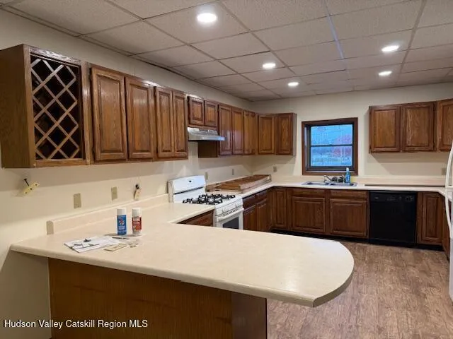 a kitchen with a sink a stove and cabinets