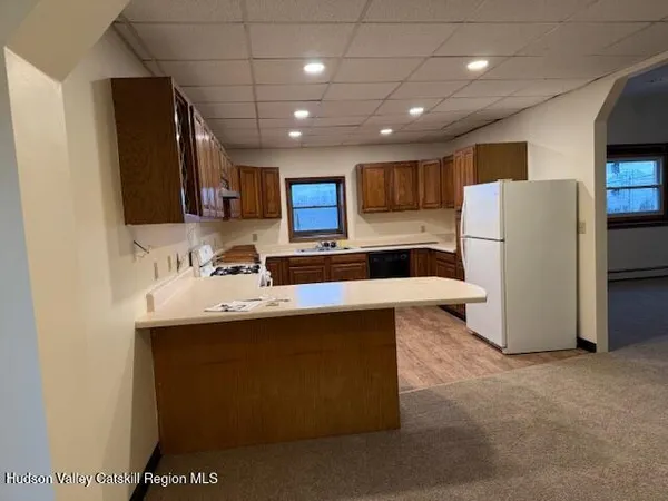 a kitchen with refrigerator and a sink