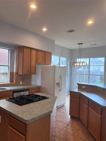 a kitchen with a stove a sink and a refrigerator