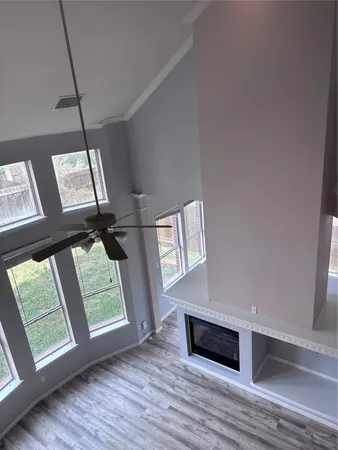 a view of an empty room with wooden floor