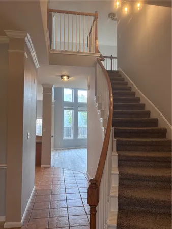 a view of entryway and hall with wooden floor