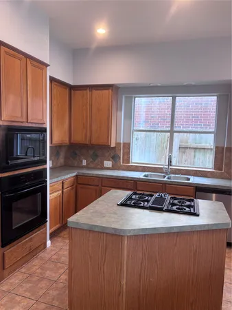a kitchen with a stove a sink and a microwave