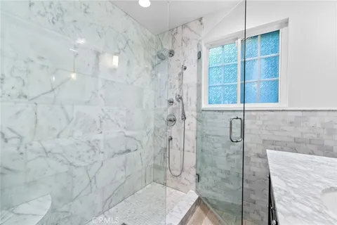 a spacious bedroom with a bed and a flat screen tv