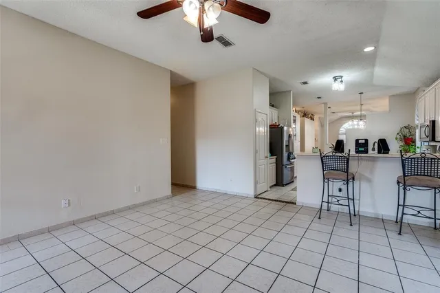 a view of a livingroom with furniture and a chandelier fan