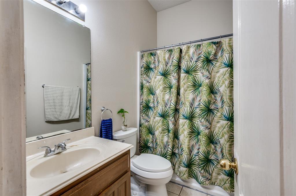 9120 River Trails Boulevard Fort Worth, TX 76118 - Photo 15 of 25 a bathroom with a sink mirror vanity and toilet