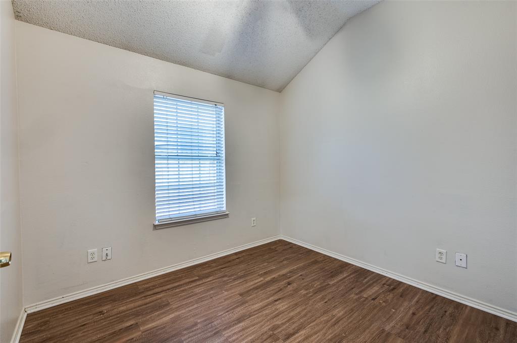 9120 River Trails Boulevard Fort Worth, TX 76118 - Photo 16 of 25 a view of an empty room with wooden floor and a window