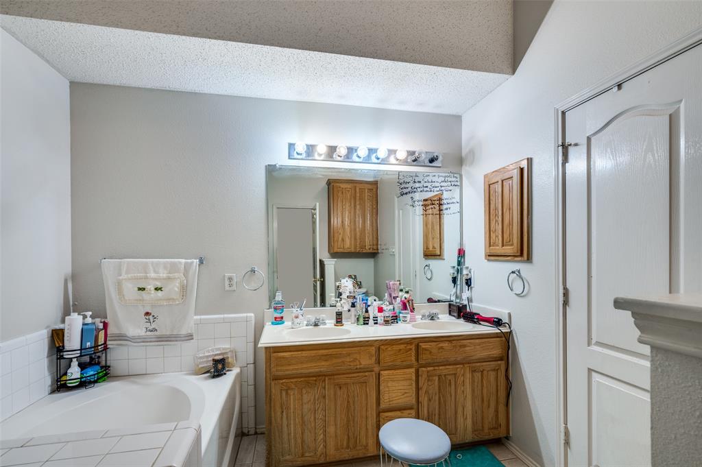 9120 River Trails Boulevard Fort Worth, TX 76118 - Photo 20 of 25 a bathroom with a sink double vanity and a mirror