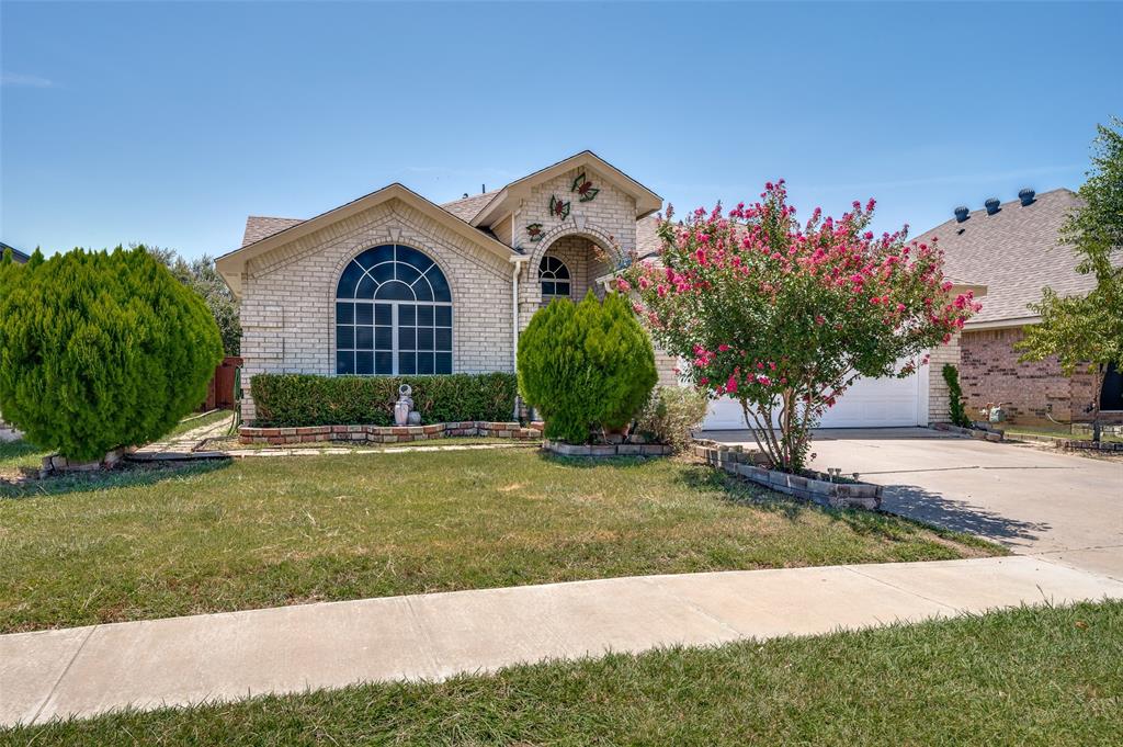 9120 River Trails Boulevard Fort Worth, TX 76118 - Photo 2 of 25 a front view of a house with a yard and garage