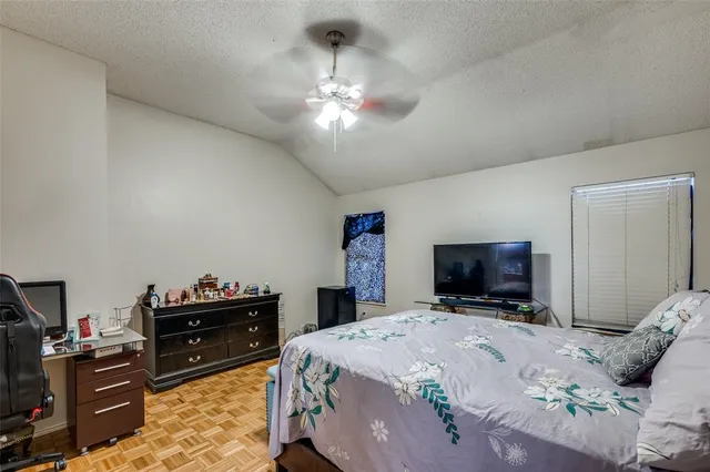 a bedroom with a bed and a television