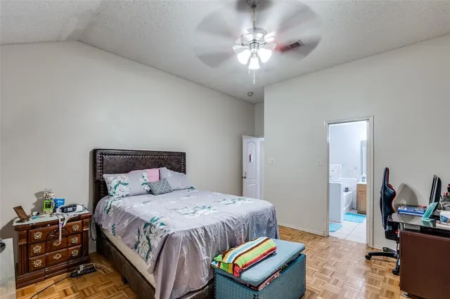 a bedroom with a bed a chandelier and closet