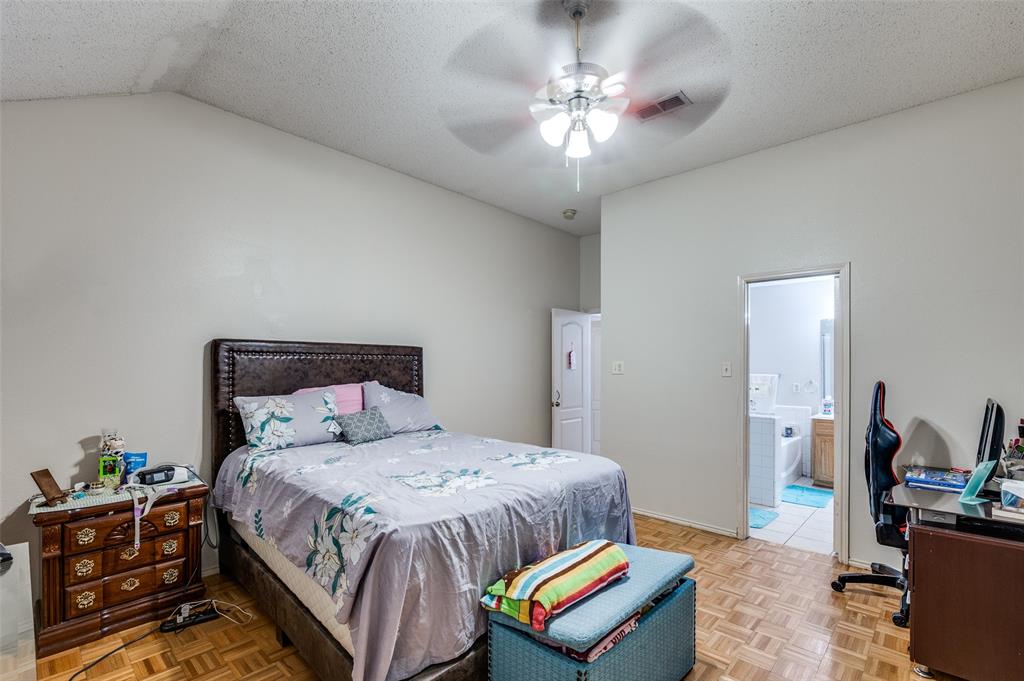 9120 River Trails Boulevard Fort Worth, TX 76118 - Photo 22 of 25 a bedroom with a bed a chandelier and closet