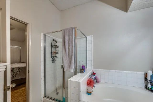 a bathroom with a tub shower and a sink