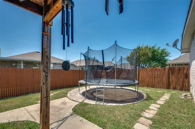 a swimming pool with outdoor seating and yard