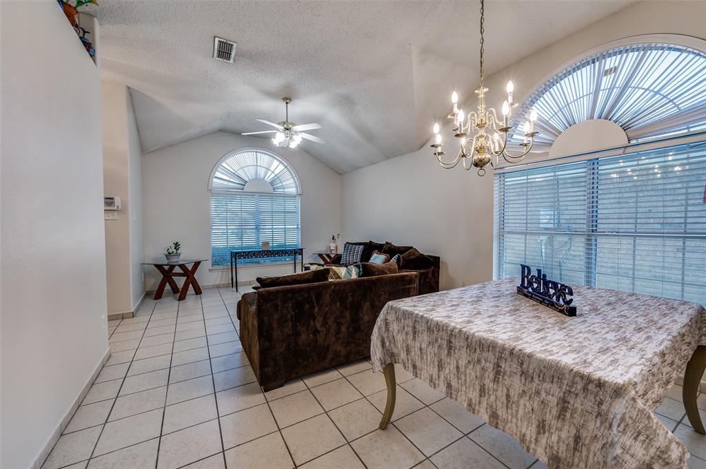 9120 River Trails Boulevard Fort Worth, TX 76118 - Photo 7 of 25 a bedroom with a bed and a chandelier