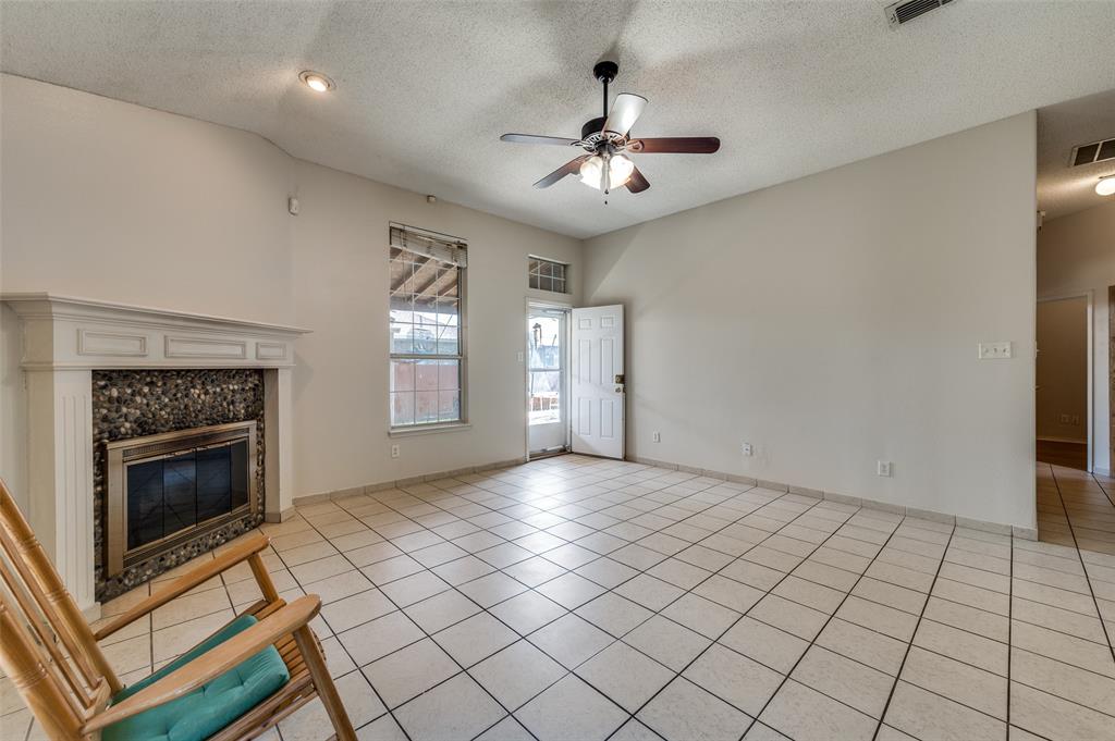9120 River Trails Boulevard Fort Worth, TX 76118 - Photo 9 of 25 a view of an empty room with window and fire place