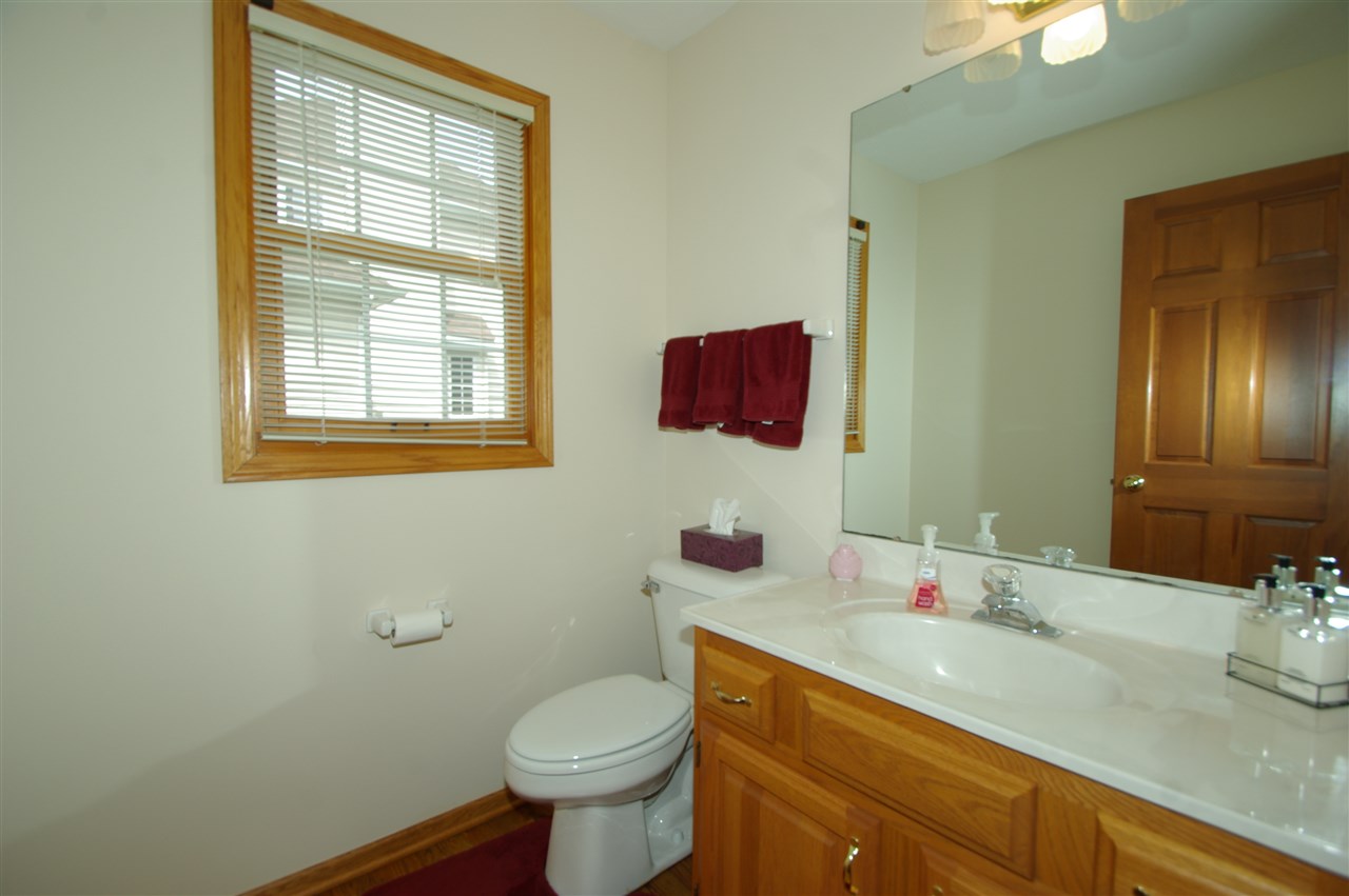 7254 Sentinel Road Rockford, IL 61107 - Photo 14 of 25 a bathroom with a toilet sink and mirror