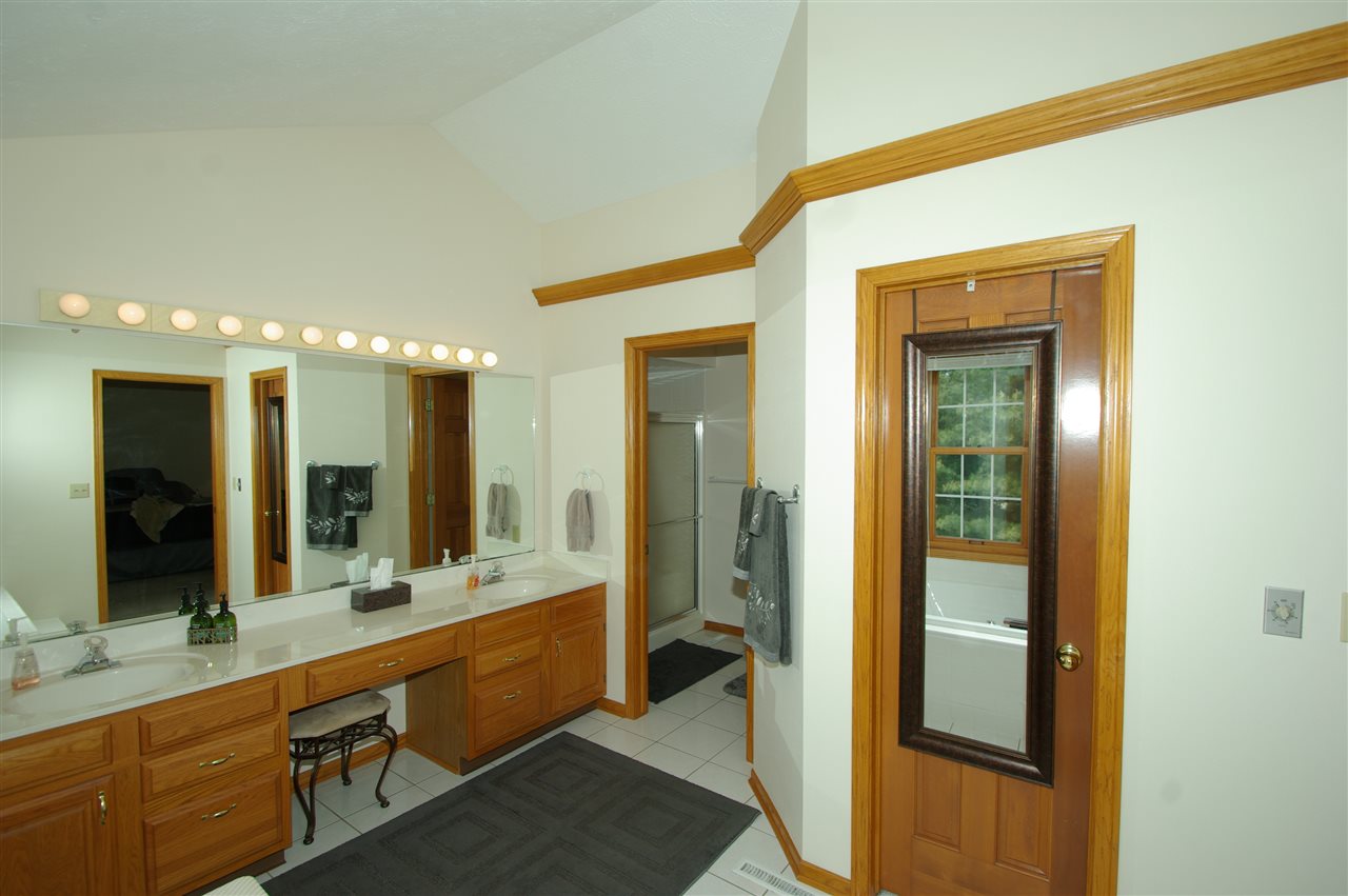 7254 Sentinel Road Rockford, IL 61107 - Photo 19 of 25 a bathroom with a double vanity sink and a mirror
