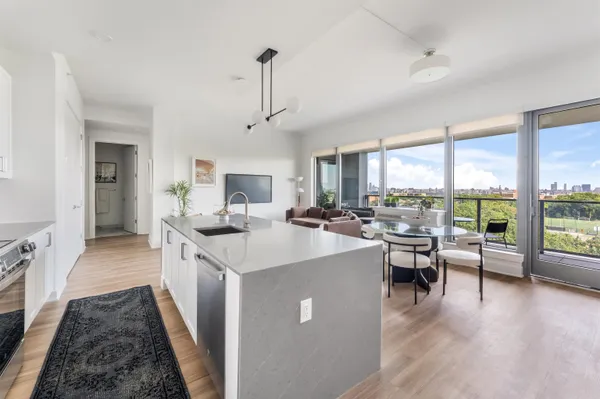 a open kitchen with stainless steel appliances granite countertop a sink stove and wooden floor