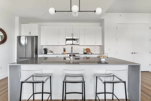 a kitchen with stainless steel appliances a sink and a refrigerator