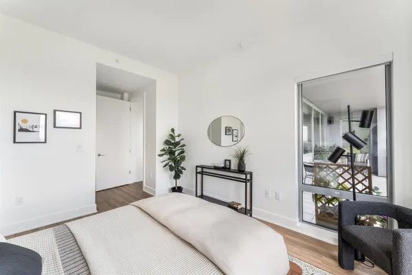 a bedroom with a bed and dresser with mirror
