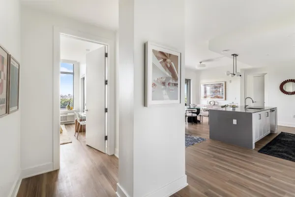 a view of a living room kitchen and a wooden floor