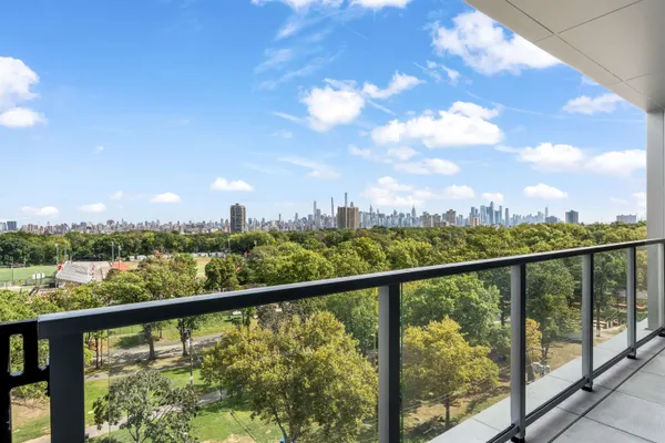 a view of city and mountain from a balcony