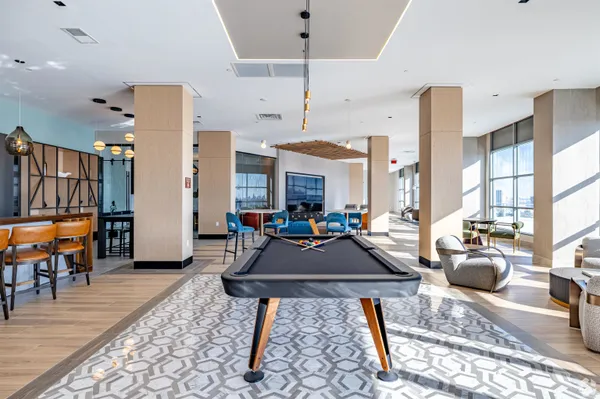 a living room with furniture a table and chairs