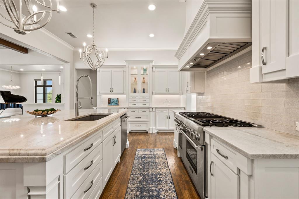 809 Legacy Trail Colleyville, TX 76034 - Photo 14 of 40 a large white kitchen with stainless steel appliances granite countertop a stove and a sink