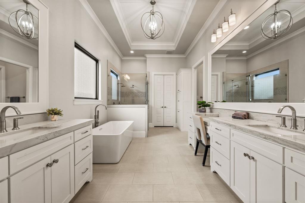 809 Legacy Trail Colleyville, TX 76034 - Photo 20 of 40 a spacious bathroom with a double vanity sink a mirror and a bathtub