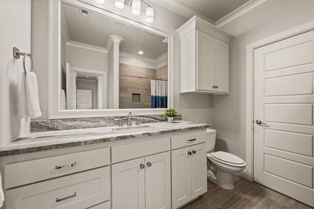 809 Legacy Trail Colleyville, TX 76034 - Photo 26 of 40 a bathroom with a granite countertop toilet sink and a mirror